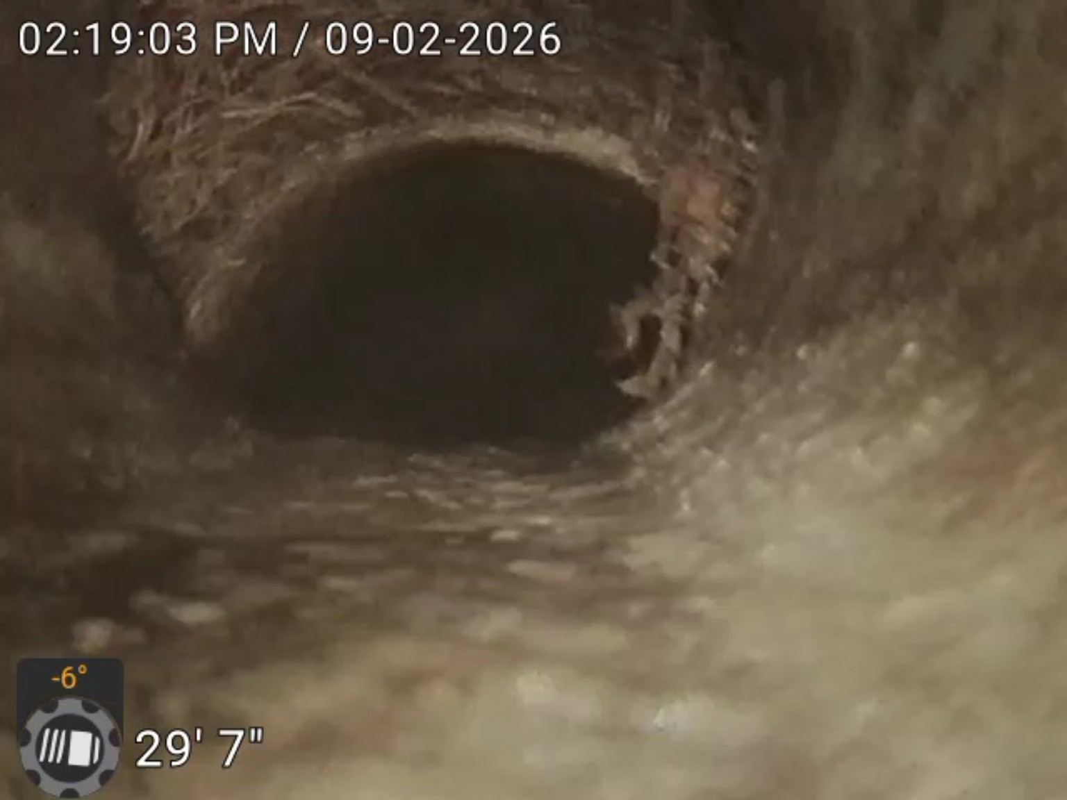 Drain camera image showing an apparent offset at a pipe joint near the 29-foot-7-inch distance marker
